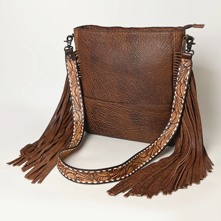 Introducing the Large Crossbody Simple Leather with Fringe by American Darling, a rectangular brown leather crossbody bag featuring decorative floral designs on the shoulder strap and long fringe details on both sides. Exuding bohemian flair, this bag has a textured finish that adds to its unique charm.