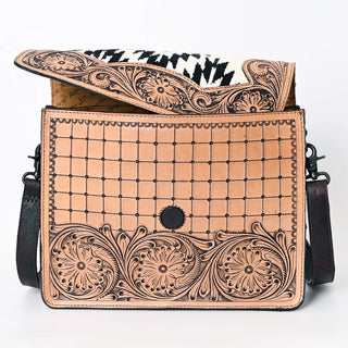 Introducing the Western Tooled Messenger Purse from Western Edge Boutique: This stylish handbag is crafted from genuine leather and showcases intricate floral and Aztec patterns on the flap and front. The open top reveals an interior lined with a black and white patterned fabric, complemented by a dark strap featuring elegant tooled detailing on the sides.