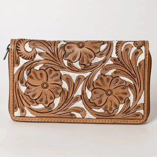 The Percie Cowhide Tooled Wallet by American Darling is crafted from tan cowhide and features an intricate floral embossed design. The flowers and leaves are prominently raised, adding texture and detail to the front. It has a zipper along the top edge, with a neutral light gray background enhancing its elegance.