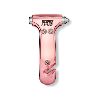 The BLINGSTING Emergency Escape Hammer is a pink, hammer-shaped safety tool from the women's personal safety brand. It features a high-quality carbide tip for breaking glass, a built-in blade for cutting seat belts, and three visible screws on the front.