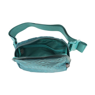 An open teal fanny pack with a diamond pattern, showcasing its main zippered compartment. The strap and buckle are adjusted to an open length, making this vibrant accessory from C.C Beanie's Southwest Patterned C.C Belt Bag collection stand out with jewel-toned accents that perfectly complement its southwestern design.