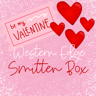 A card with a pink glittery background features a stamp reading "be my VALENTINE." Scattered red hearts of various sizes surround the text "Pre Order Western Edge Boutique's Smitten Over You Valentine's Boxes.