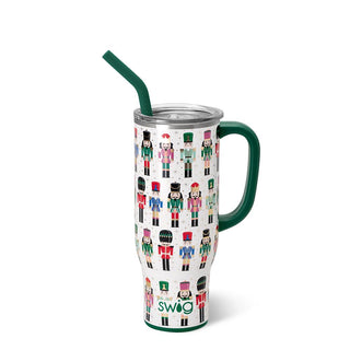 The Nutty Nutcracker from Western Edge Boutique is a 30oz insulated tumbler featuring a handle and green straw. It displays a lively nutcracker pattern in multiple colors on a white background, bringing a whimsical touch to your drinkware collection.