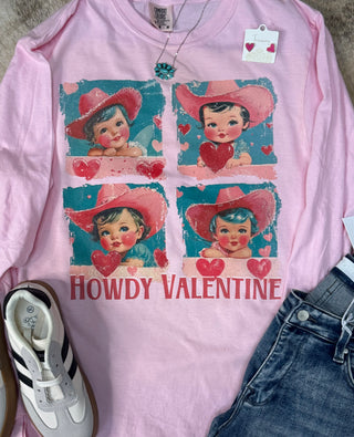 Celebrate Valentine’s Day in style with Western Edge Boutique's Howdy Valentine Graphic Tee. This pink long-sleeve tee features "Howdy Valentine" text with vintage-style illustrations of a child in a cowboy hat and hearts, perfect when paired with jeans and sneakers for a playful look.