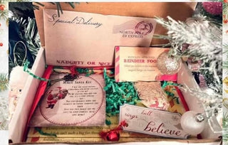 Introducing the Magical Christmas Boxes by Western Edge Boutique: a festive collection featuring a "Special Delivery" letter, a "Naughty or Nice" label, a reindeer food tag, a "Santa Magical Key" card, and an enchanting bell for believers. Each box is beautifully adorned with tinsel and includes a charming little bauble.