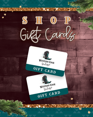 A festive advertisement features two E-Gift Cards from Western Edge Boutique displayed on a dark wood background, accented with pine branches and gold elements. The stylish text encourages you to "Shop Gift Cards," providing a simple way to gift trendy fashion items this holiday season.