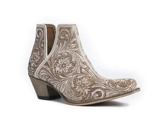 Introducing the White Chocolate Tooled Booties by Myra, featuring a striking combination of brown and white with intricate floral and swirl patterns. These ankle boots boast a low wooden cowboy heel and a pointed toe, showcasing detailed craftsmanship and stylish design reminiscent of Western hand-tooled leather booties.