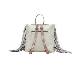 Introducing the Myra SMOKEY BACKPACK LEATHER & HAIRON BAG, a stylish backpack featuring a white body and textured pink straps. It boasts two shoulder straps adorned with a striking snakeskin pattern and unique hair-on cowhide fringe details extending from both sides, adding a trendy touch.