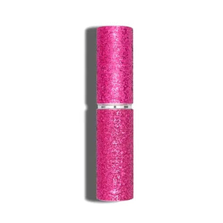 The Emergency Mini Stunna by BLINGSTING is a pink glittery tube of lipstick with a shiny finish, standing vertically against a white background. The tube features a metallic silver band in the middle, indicating it can be twisted to open - charged with high voltage glamour.