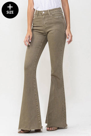 A person is modeling Ellis High-Rise Super Flare Jeans by VERVET by Flying Monkey, crafted from stretch denim in an olive-green hue with a frayed hem. Featuring two front and two back pockets, these high-waisted jeans are paired effortlessly with a simple white top. The image includes a "+ size" icon in the top left corner.