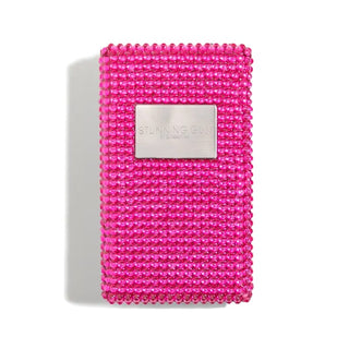 A rectangular, hot pink stun gun adorned with numerous small, shiny beads ensures women's safety. The device features a metallic label in the center displaying the text "Emergency Big Stun Gun" followed by "BY BLINGSTING." The item's shadow is visible to the left.