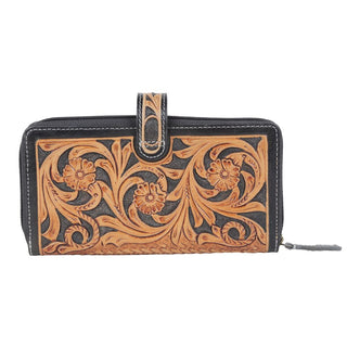 Introducing the Laken Tooled Leather Wallet by Western Edge Boutique—a beautifully crafted rectangular wallet featuring embossed floral and swirl patterns in a tan color, elegantly set against a black background. This wallet is designed with a snap closure tab at the top and a zippered finish around the edges for added security.